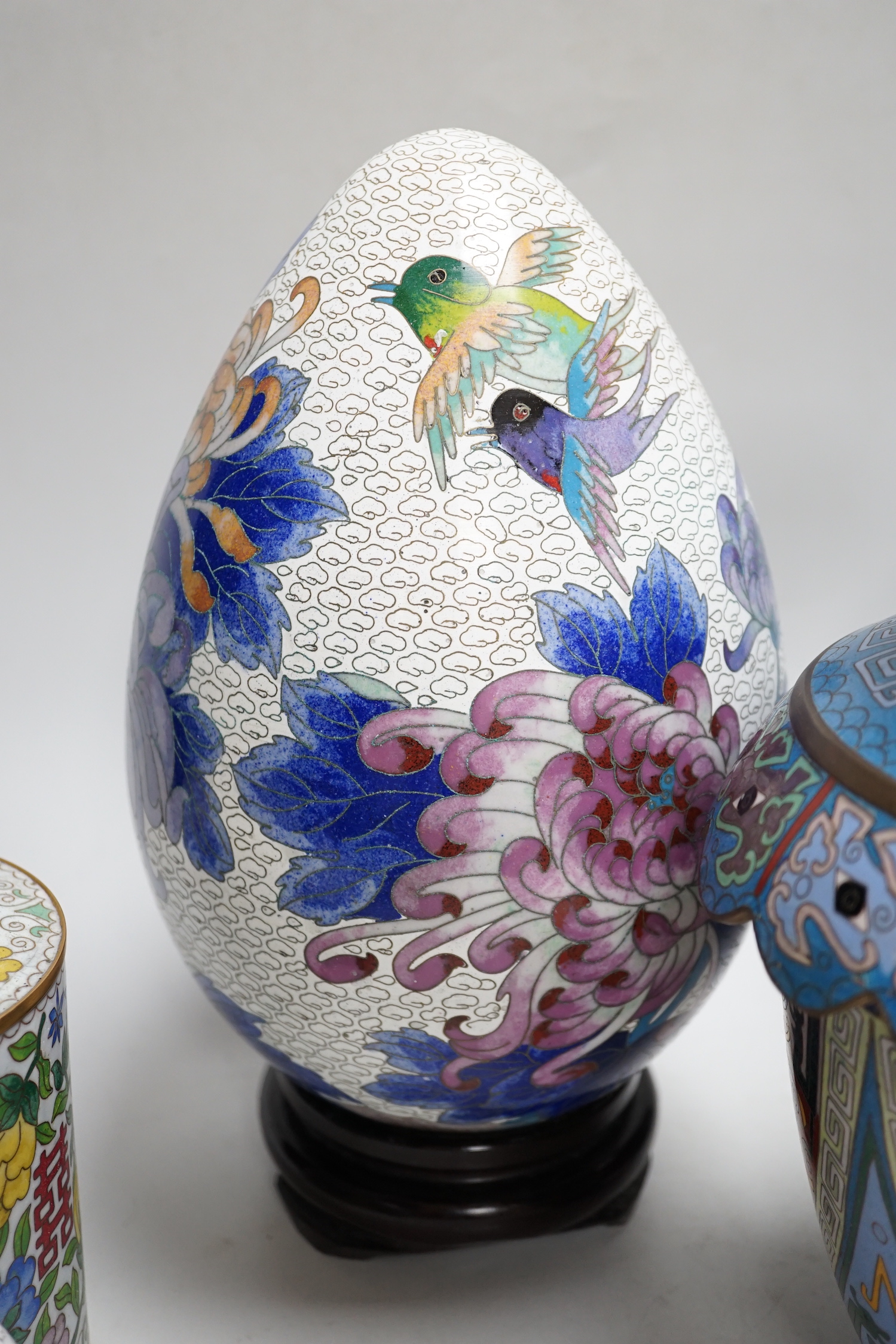 A pair of Chinese cloisonné enamel vases, a pair of canisters and covers, a large egg on stand and a small egg on stand